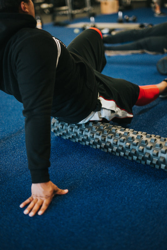 man on roller in sports gym Photo by Andrew Valdivia on Unsplash