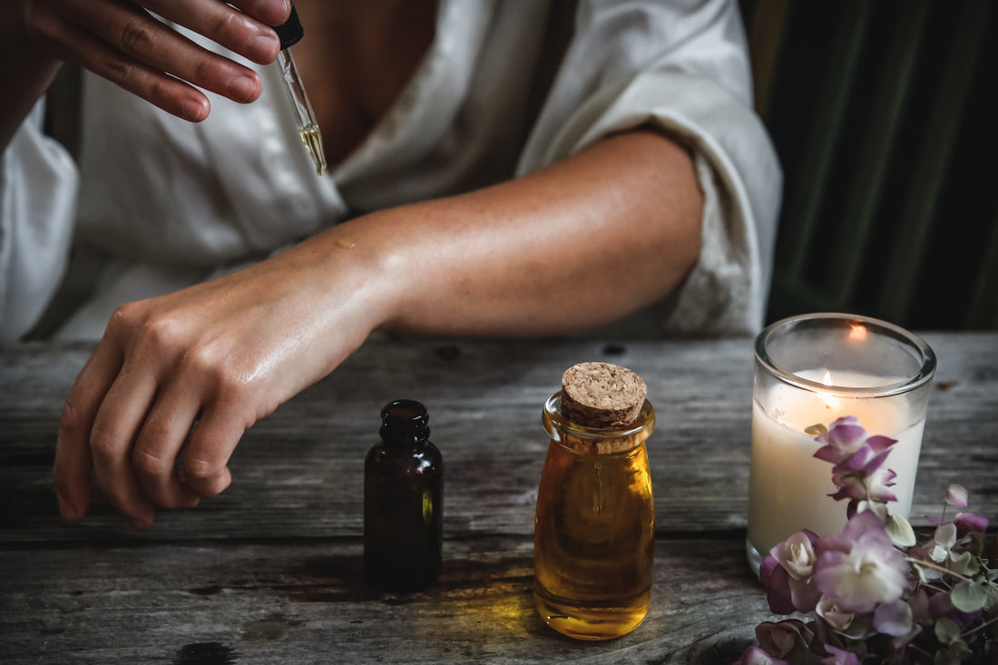 woman dropping essential oil on her hands Photo by Chelsea shapouri on Unsplash
