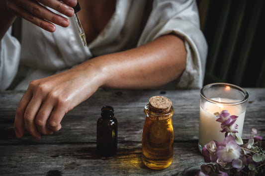woman dropping essential oil on her hands Photo by Chelsea shapouri on Unsplash
