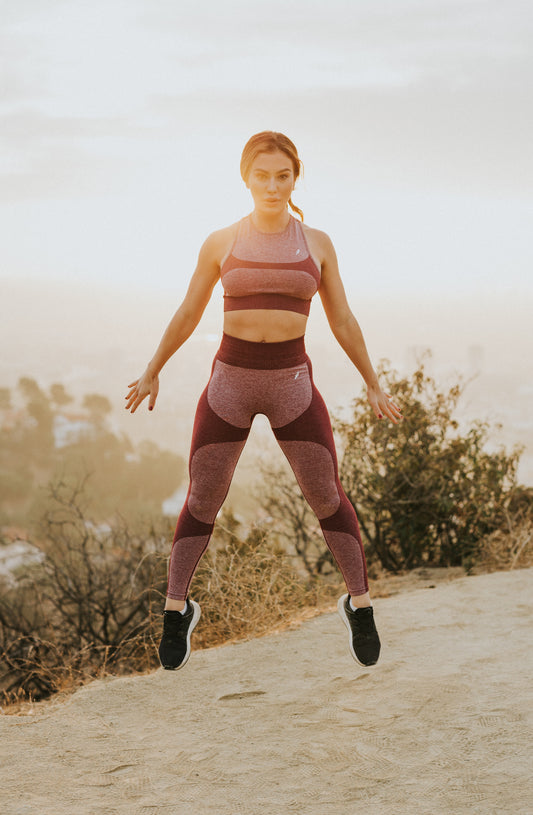 woman jumping in hilly area. Photo by MARK ADRIANE on Unsplash